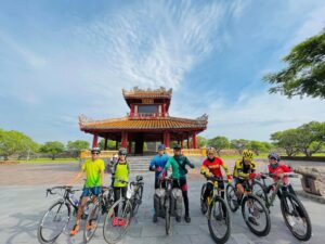 a group of people on bicycles in front of a pagoda