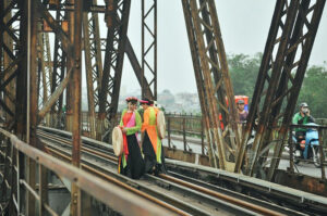 a group of people walking on a bridge